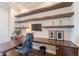 Sophisticated office space with custom shelving, built-in desk, and ample storage at 36298 N Crucillo Dr, Queen Creek, AZ 85140