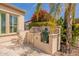 Outdoor kitchen with built-in grill, lush trees, and desert landscaping with stone accents at 36298 N Crucillo Dr, Queen Creek, AZ 85140