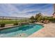 Backyard swimming pool, spa and patio area overlooking a lush golf course with mature trees at 36298 N Crucillo Dr, Queen Creek, AZ 85140