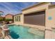 Beautiful pool with tanning ledge and covered patio for relaxing or entertaining outdoors at 36298 N Crucillo Dr, Queen Creek, AZ 85140