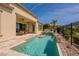 Gorgeous backyard pool with a mini-waterfall, outdoor kitchen and dining area with golf course view at 36298 N Crucillo Dr, Queen Creek, AZ 85140
