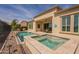 Backyard pool and spa with patio and lush landscaping overlooking a scenic golf course at 36298 N Crucillo Dr, Queen Creek, AZ 85140