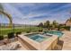 Beautiful backyard pool and jacuzzi with scenic golf course view and desert landscaping at 36298 N Crucillo Dr, Queen Creek, AZ 85140