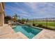 Stunning backyard pool and golf course view, with lush landscaping and outdoor kitchen at 36298 N Crucillo Dr, Queen Creek, AZ 85140