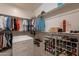 Well-organized walk-in closet with shelves, rods, and storage, for ample space for clothes and shoes at 36298 N Crucillo Dr, Queen Creek, AZ 85140