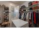 This spacious walk-in closet features ample shelving and hanging storage for optimal organization at 36298 N Crucillo Dr, Queen Creek, AZ 85140