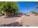 Expansive backyard featuring neutral rock landscaping, mature trees, and a pool at 3823 E Poinsettia Dr, Phoenix, AZ 85028