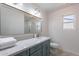Updated bathroom featuring a marble vanity, a stylish mirror, and modern fixtures at 3823 E Poinsettia Dr, Phoenix, AZ 85028