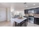 Open concept kitchen adjacent to the living room and featuring stainless appliances and center island at 3823 E Poinsettia Dr, Phoenix, AZ 85028
