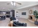 Open floor plan with the living room adjacent to an updated kitchen, fireplace, and back patio access at 3823 E Poinsettia Dr, Phoenix, AZ 85028
