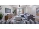 Inviting living room featuring a comfortable gray sectional sofa, ceiling fan, and neutral color palette at 3823 E Poinsettia Dr, Phoenix, AZ 85028