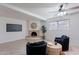 Bright and airy living room featuring a cozy fireplace and comfortable seating with a view to the backyard at 3823 E Poinsettia Dr, Phoenix, AZ 85028