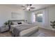 Tranquil main bedroom with soft gray tones, plush bedding, and a bright window at 3823 E Poinsettia Dr, Phoenix, AZ 85028