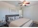 Comfortable main bedroom featuring neutral tones, a ceiling fan, and a cozy bed with ample pillows at 3823 E Poinsettia Dr, Phoenix, AZ 85028