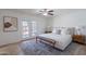 Serene main bedroom with wood-look floors, French doors, and a cozy seating bench at 3823 E Poinsettia Dr, Phoenix, AZ 85028