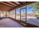 Screened patio with a view of the pool and a landscaped backyard with palm trees at 3823 E Poinsettia Dr, Phoenix, AZ 85028