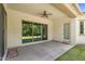 Covered back patio with ceiling fan and access to backyard oasis through sliding glass doors at 3872 E Jude Ln, Gilbert, AZ 85298