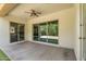 The covered patio has a fan and is open to the spacious backyard with artificial turf and manicured landscaping at 3872 E Jude Ln, Gilbert, AZ 85298