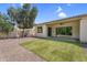 This backyard featuring desert landscaping, a patio, and well manicured green space offers low-maintenance enjoyment at 3872 E Jude Ln, Gilbert, AZ 85298