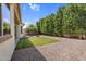 This backyard featuring desert landscaping, a patio, a grill, and mature trees offers privacy at 3872 E Jude Ln, Gilbert, AZ 85298