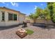 Backyard featuring desert landscaping, a patio, a grill, a garden box, and mature trees at 3872 E Jude Ln, Gilbert, AZ 85298