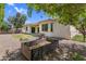 This backyard featuring desert landscaping, a patio, a grill, and a garden box offers low-maintenance enjoyment at 3872 E Jude Ln, Gilbert, AZ 85298