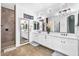 Bright bathroom with double sinks, a large mirror, and a tiled walk-in shower, perfect for everyday use at 3872 E Jude Ln, Gilbert, AZ 85298