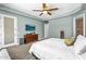 Relaxing bedroom featuring a ceiling fan, mounted TV, and a cozy bed with stylish throw pillows at 3872 E Jude Ln, Gilbert, AZ 85298