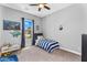 Bedroom with a striped bedspread, bright window, and fun decor at 3872 E Jude Ln, Gilbert, AZ 85298