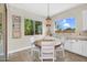 Cozy breakfast nook with tile floor, white cabinets, and two large windows with views to the backyard at 3872 E Jude Ln, Gilbert, AZ 85298