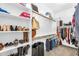 Walk-in closet providing generous storage space for shoes, handbags, and clothing items on multiple shelves at 3872 E Jude Ln, Gilbert, AZ 85298