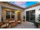 Cozy courtyard with outdoor seating, a water feature, and soft lighting at 3872 E Jude Ln, Gilbert, AZ 85298