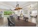 Open-concept dining room featuring modern chandelier and open access to living and kitchen areas at 3872 E Jude Ln, Gilbert, AZ 85298