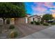Charming home with a two-car garage, beautiful landscaping, and a brick driveway at 3872 E Jude Ln, Gilbert, AZ 85298