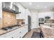 Elegant kitchen featuring granite counters, stainless appliances, white cabinets, and decorative backsplash at 3872 E Jude Ln, Gilbert, AZ 85298