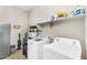 Functional laundry room featuring modern appliances and convenient overhead storage for supplies at 3872 E Jude Ln, Gilbert, AZ 85298