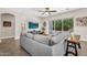 Bright living room with a gray sectional, modern decor, and a view of the backyard at 3872 E Jude Ln, Gilbert, AZ 85298