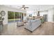 Open concept living room with tile flooring, a large sectional, and a view into the kitchen at 3872 E Jude Ln, Gilbert, AZ 85298