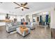 Open-concept living space with tile flooring, modern furnishings, and seamless flow to the kitchen and dining area at 3872 E Jude Ln, Gilbert, AZ 85298