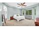 Serene bedroom features a ceiling fan, natural light, and a cozy seating area for relaxation at 3872 E Jude Ln, Gilbert, AZ 85298