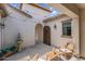 Charming patio featuring a wooden door, outdoor furniture, and a decorative tiered fountain at 3872 E Jude Ln, Gilbert, AZ 85298