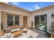 Inviting outdoor patio area with string lights, comfortable seating, and a water fountain feature at 3872 E Jude Ln, Gilbert, AZ 85298