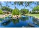 Scenic pond with rock waterfall and lush landscaping offers a tranquil spot for relaxation and reflection at 3872 E Jude Ln, Gilbert, AZ 85298