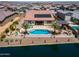 Aerial view of the backyard featuring a pool, patio, fire pit, and waterfront location at 40725 W Hall Dr, Maricopa, AZ 85138
