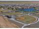 Aerial view of ball fields with lake and residential neighborhood in the background at 40725 W Hall Dr, Maricopa, AZ 85138