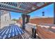 Backyard patio featuring a pergola, outdoor kitchen, and dining area, ideal for entertaining at 40725 W Hall Dr, Maricopa, AZ 85138