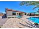 Stunning backyard pool with sun loungers and a covered patio, perfect for relaxing outdoors at 40725 W Hall Dr, Maricopa, AZ 85138