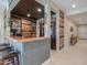 Custom bar boasts unique wood paneling, corrugated metal accents, and ample shelving for beverages at 40725 W Hall Dr, Maricopa, AZ 85138