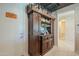 Wet bar featuring custom cabinetry, shelving, and space for beverages, creating an entertaining area at 40725 W Hall Dr, Maricopa, AZ 85138