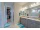Bright bathroom with double sink vanity, granite countertop and decorative lighting at 40725 W Hall Dr, Maricopa, AZ 85138